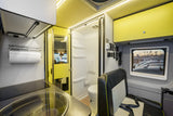 RV rental: Compact, modern camper interior with kitchenette, wet bath, & passenger seating.