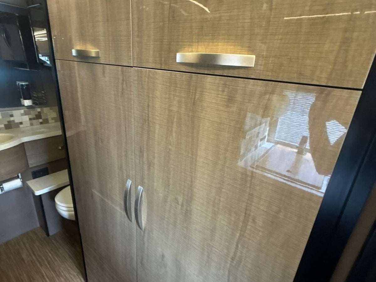  perfect for road trips.|Explore in style! This silver Winnebago Touring Coach rv rental camper van features an open side door & rear spare tire.|Silver Winnebago Touring Coach RV rental — photo 16