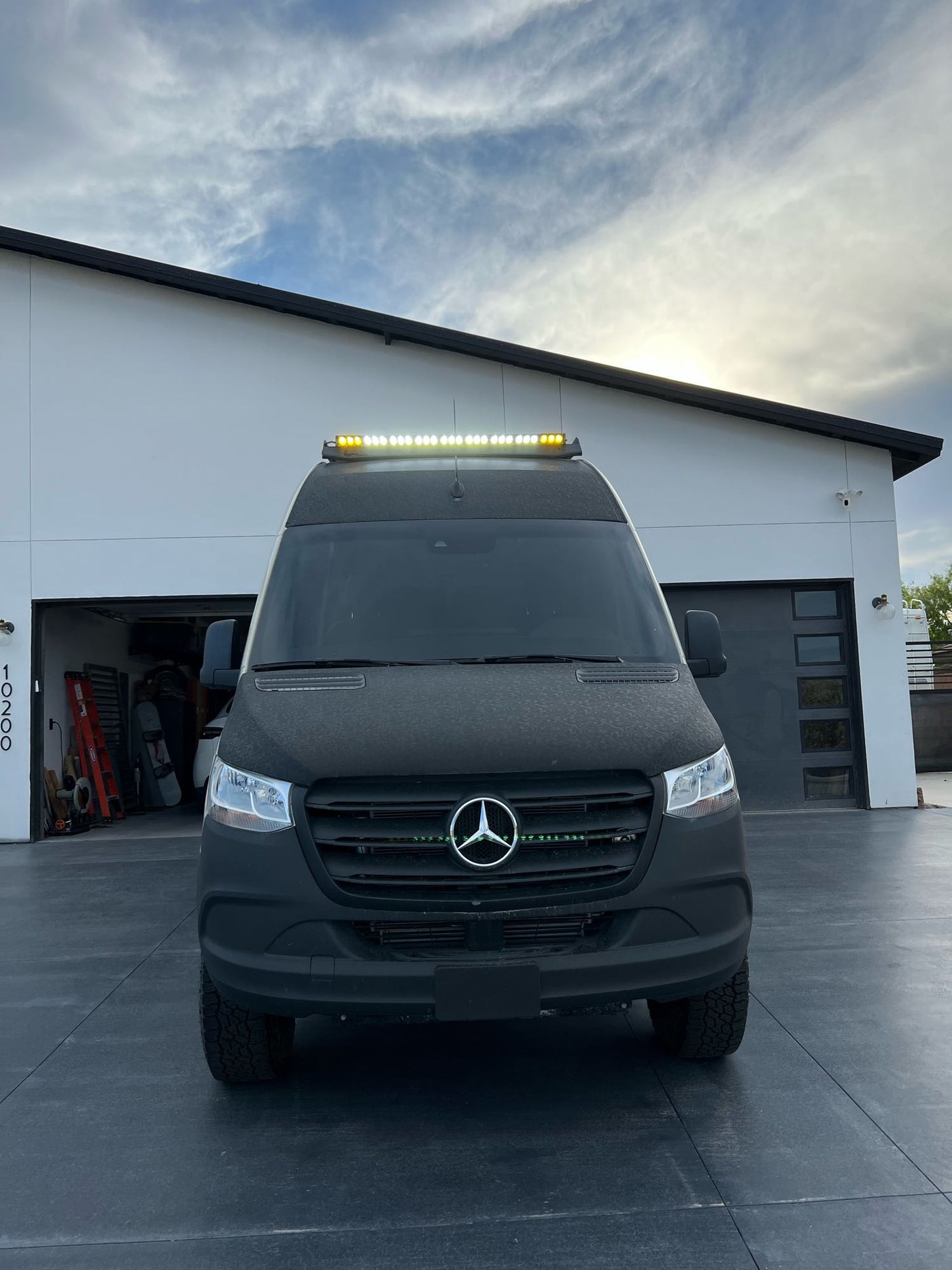  parked by a modern house.|This rugged Mercedes Sprinter adventure van — photo 10