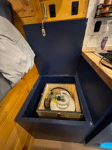 RV rental storage: Open blue compartment holds propane tank.
