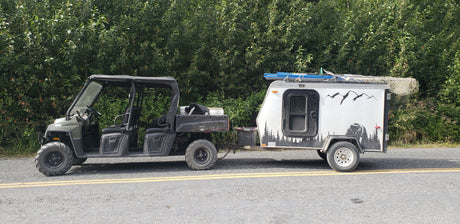 Off-road Polaris Ranger UTV with custom trailer. Your next rugged RV rental for outdoor adventures!