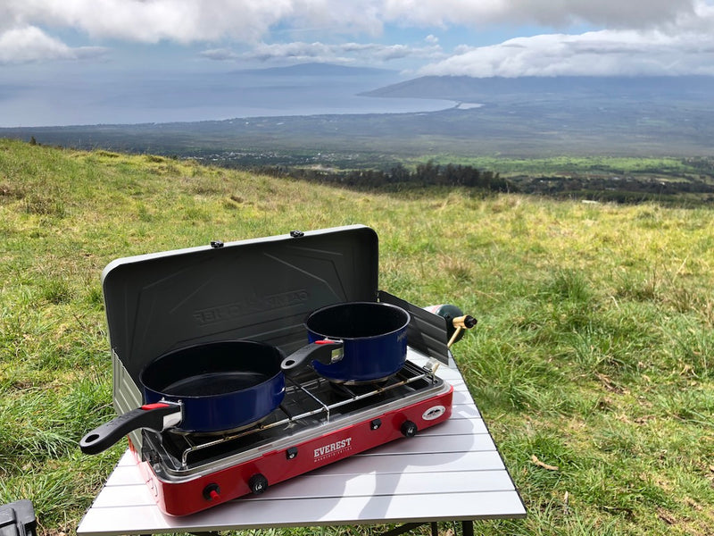 RV rental trip: Outdoor cooking on a portable stove with stunning views of the ocean and distant hills from a grassy peak. — photo 14
