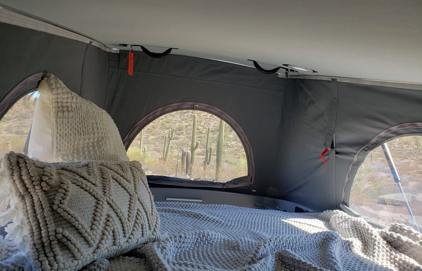  and white countertop in an RV or camper.|Cozy RV rental: A couple enjoys coffee inside their campervan — photo 2