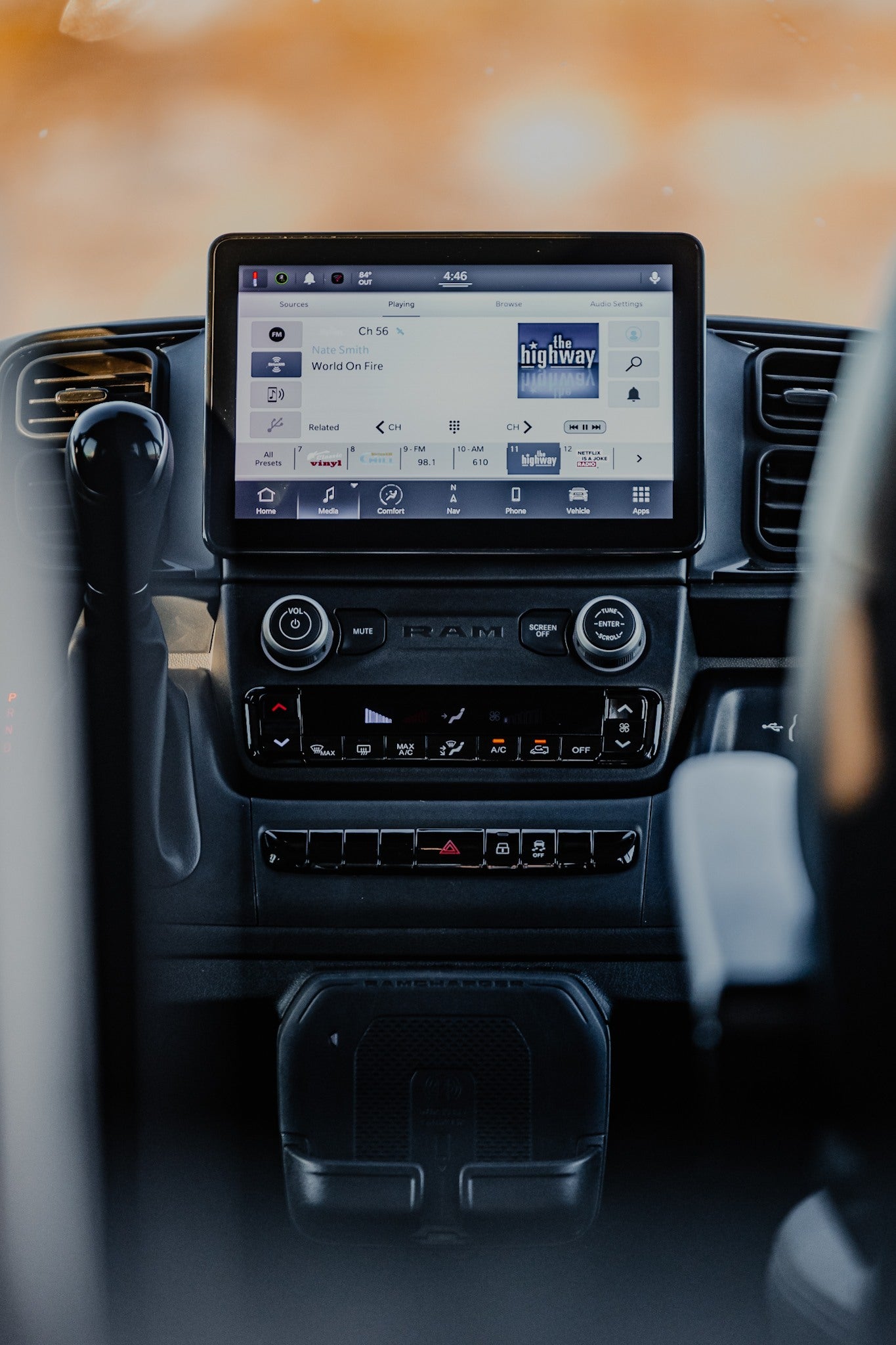 An RV rental's modern dashboard features a large infotainment screen showing music, plus climate and vehicle controls. — photo 19
