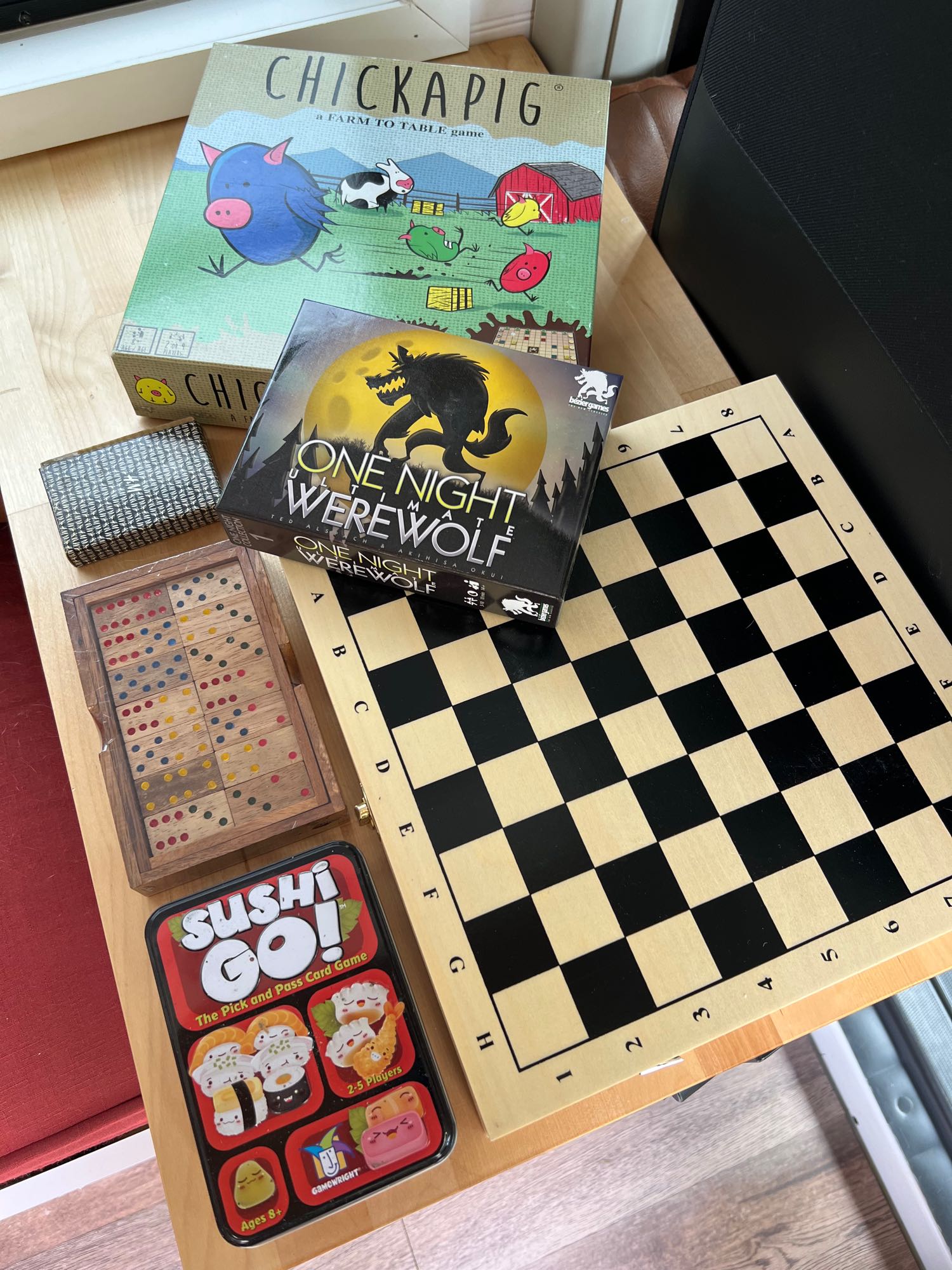 Board games, a chess set, and dominoes, perfect entertainment for an RV rental trip. Includes Chickapig, Werewolf, and Sushi Go!