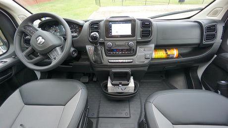 Modern RV rental van interior: driver's view of the detailed dashboard, infotainment screen, and practical cabin layout.