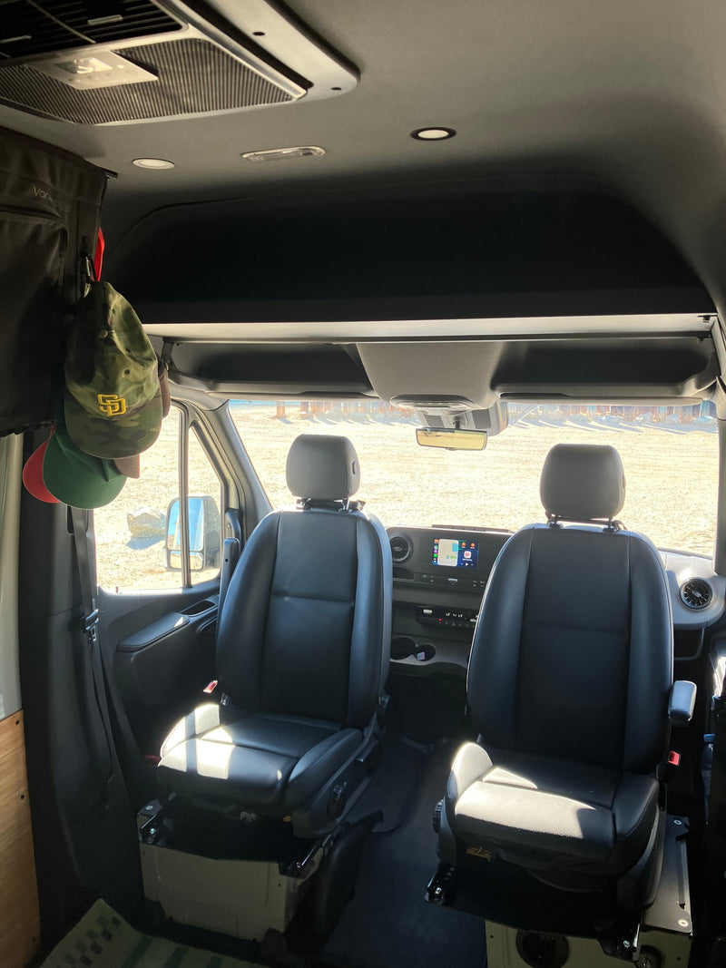  parked in a vast desert landscape with mountains & cloudy skies. Perfect for adventure travel!|RV rental van parked in a serene redwood forest with bikes — photo 13