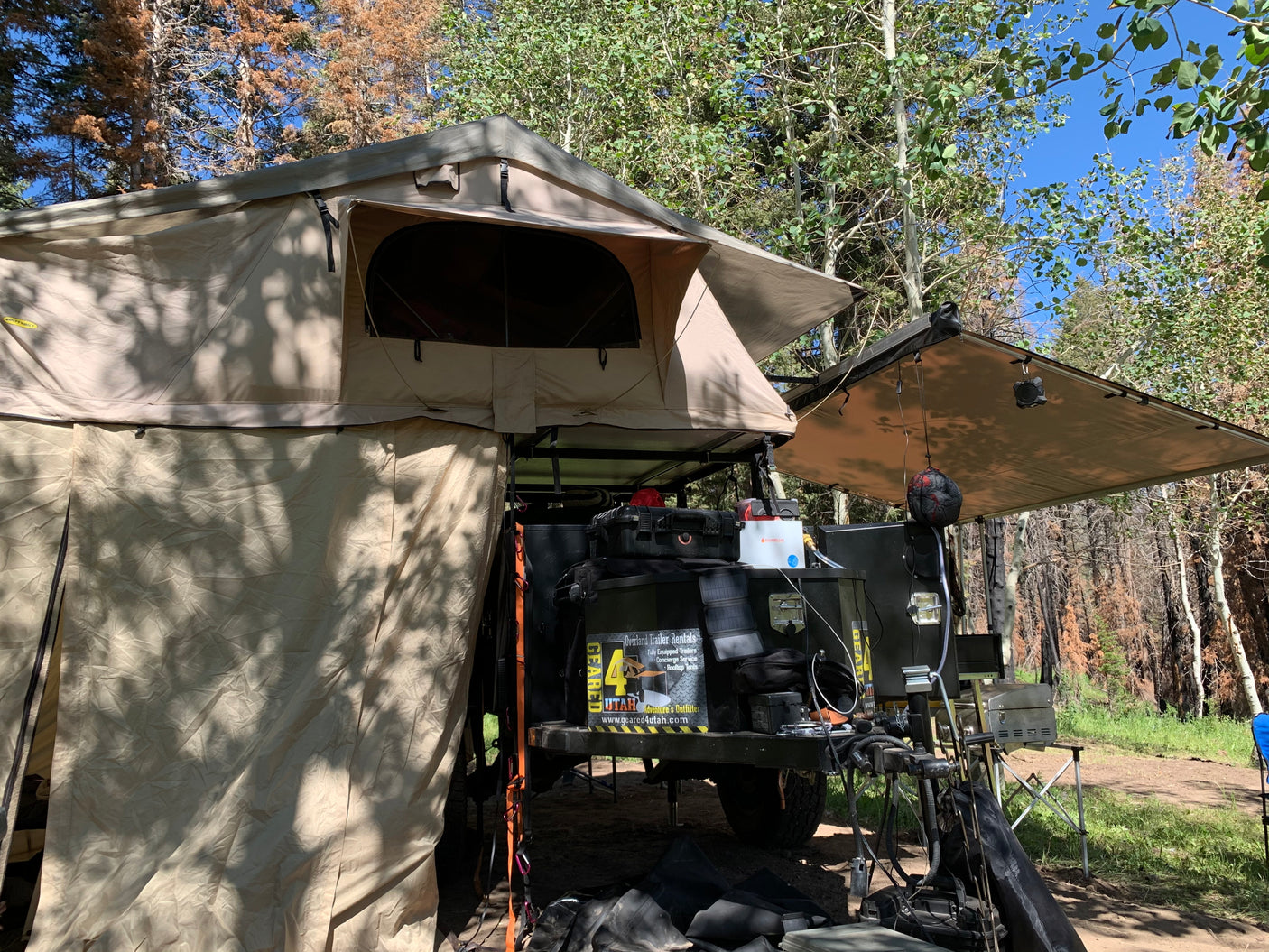 This overland trailer rv rental features a rooftop tent, awning, and full camping setup from Geared4Utah.