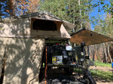 This overland trailer rv rental features a rooftop tent, awning, and full camping setup from Geared4Utah.