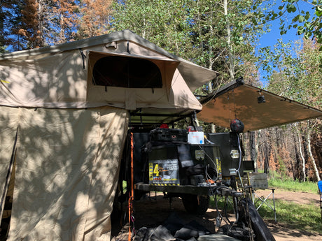 This overland trailer rv rental features a rooftop tent, awning, and full camping setup from Geared4Utah.