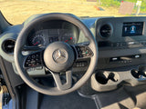 RV rental interior: driver's view of a Mercedes cockpit. Dashboard shows 'Don't Forget Your Key,' plus an infotainment screen.