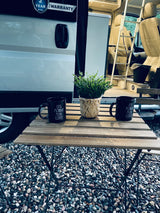 A serene morning scene outside an RV rental, featuring coffee, potted greens, and the van's inviting interior.