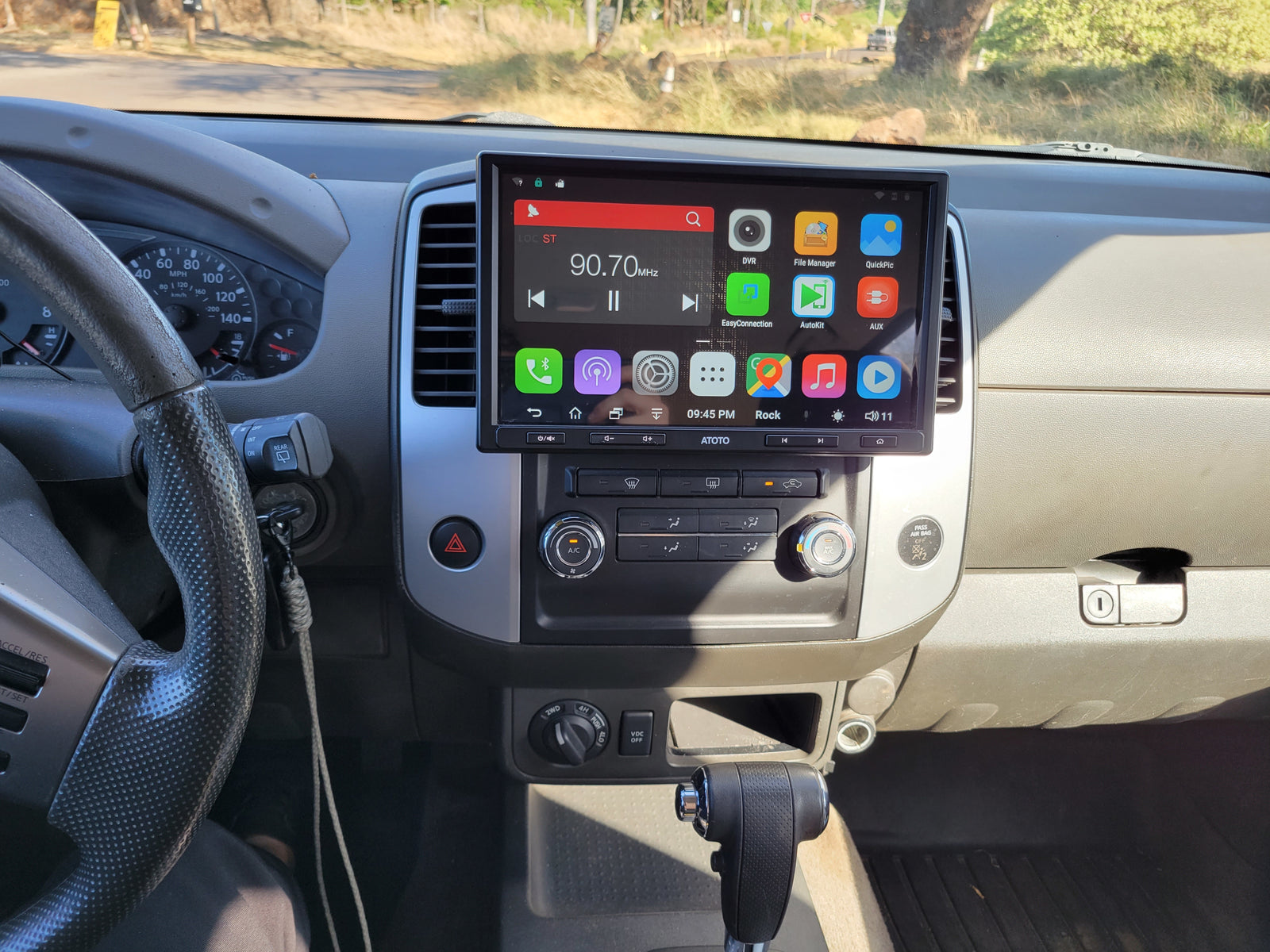 Inside an RV rental: a driver's view of the dashboard, featuring an ATOTO stereo, speedometer, and vehicle controls.