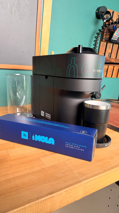 Nespresso coffee machine, NOLA chicory pods, and mug—perfect for a morning brew in your RV rental or home kitchen.