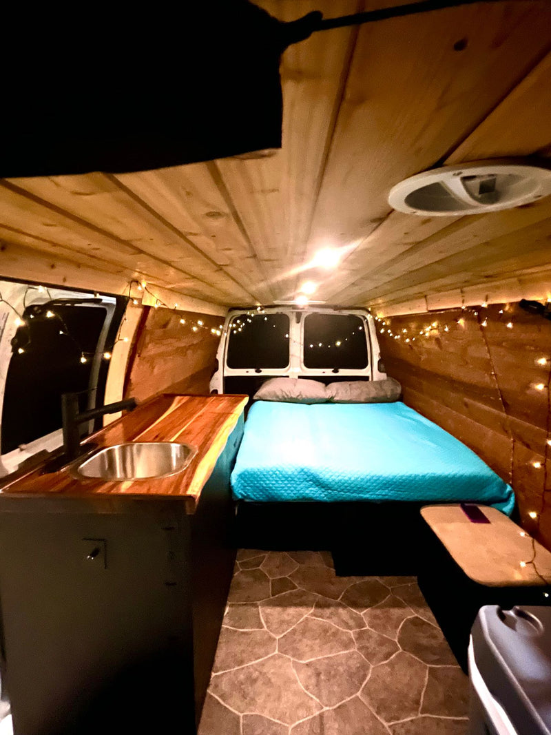  showcasing its inviting interior at night with a comfortable bed — photo 6