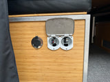 RV rental camper van interior. A bamboo utility panel features Scandvik hot/cold water connections & a hose port.