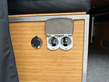 RV rental camper van interior. A bamboo utility panel features Scandvik hot/cold water connections & a hose port.