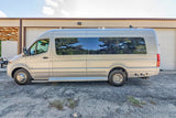 Silver Mercedes-Benz Sprinter RV rental van with tinted windows, parked on gravel outside a building. Perfect for your next adventure.