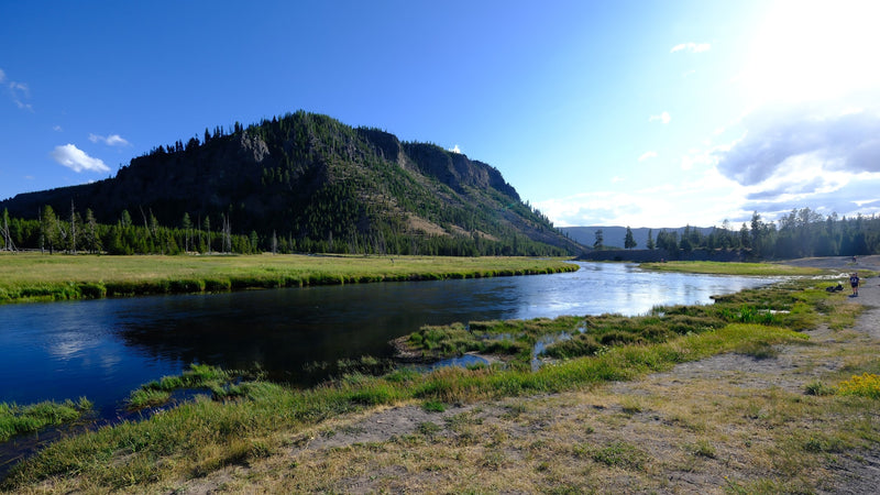  and river behind it.|RV rental travelers explore Yellowstone's Mammoth Hot Springs boardwalk — photo 13