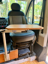 This RV rental features a versatile swivel seat and Lagun table, creating a comfortable workspace or dining area inside the camper van.