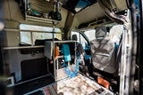 This custom camper van interior, ideal for RV rental, showcases a compact kitchenette, storage, and seating.