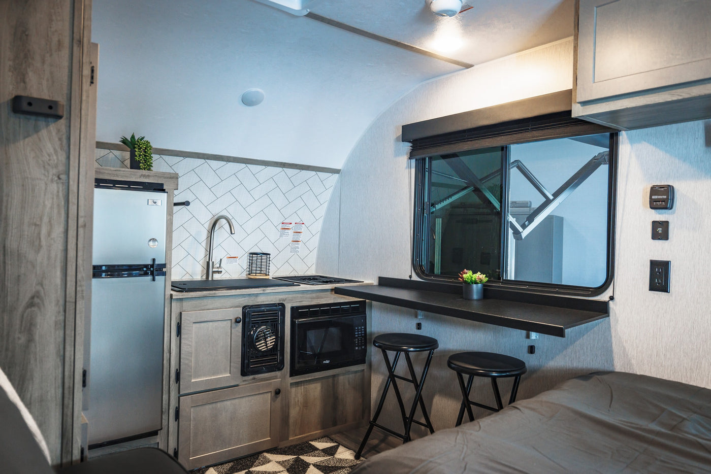  and ample storage cabinets.|This rv rental offers a well-appointed interior with a comfortable bed — photo 9