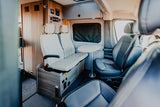 Step inside this RV rental! Comfortable seating, a versatile table, and integrated controls make it perfect for travel.