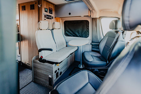 Step inside this RV rental! Comfortable seating, a versatile table, and integrated controls make it perfect for travel.