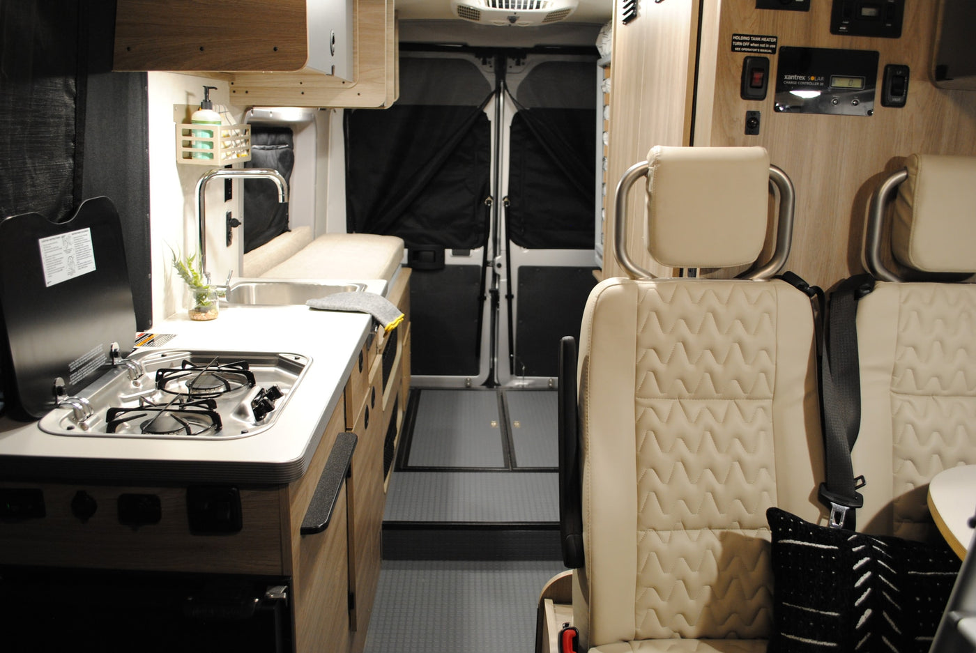  is parked by a golden lake. Perfect for your rv rental adventure.|This inviting RV rental interior features a cozy bed with stylish bedding — photo 8