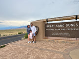 Family at the Great Sand Dunes National Park entrance, a perfect stop for an RV rental adventure and family travel memories.