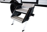 Sturdy, multi-level aluminum RV rental entry steps extended from a white camper with a rugged tire.