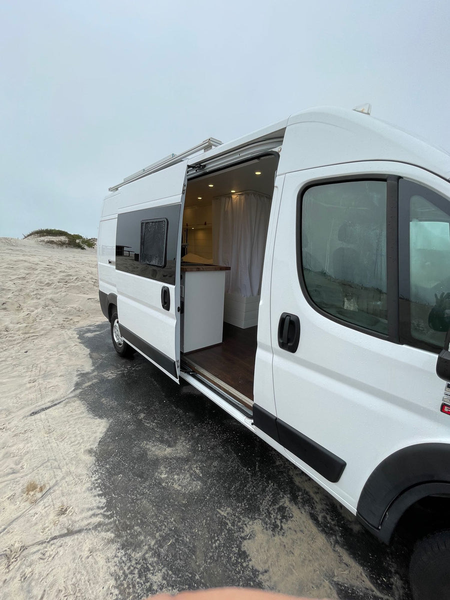  and a cozy dinette space.|An open refrigerator in a well-lit RV rental