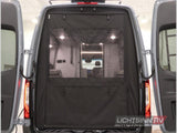 Rear view of an RV rental with open doors, featuring a black mesh screen for ventilation and privacy. Shows the camper's interior.