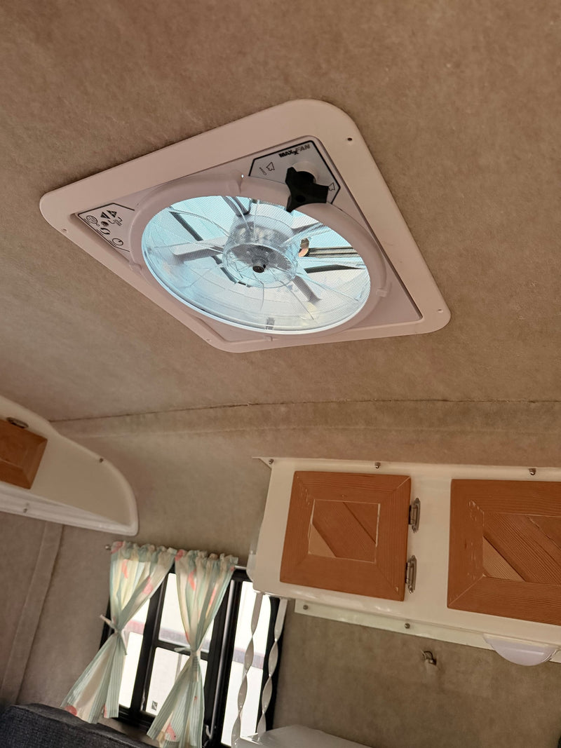  and a side seating area.|RV rental interior features a cozy dinette with a wood table — photo 13