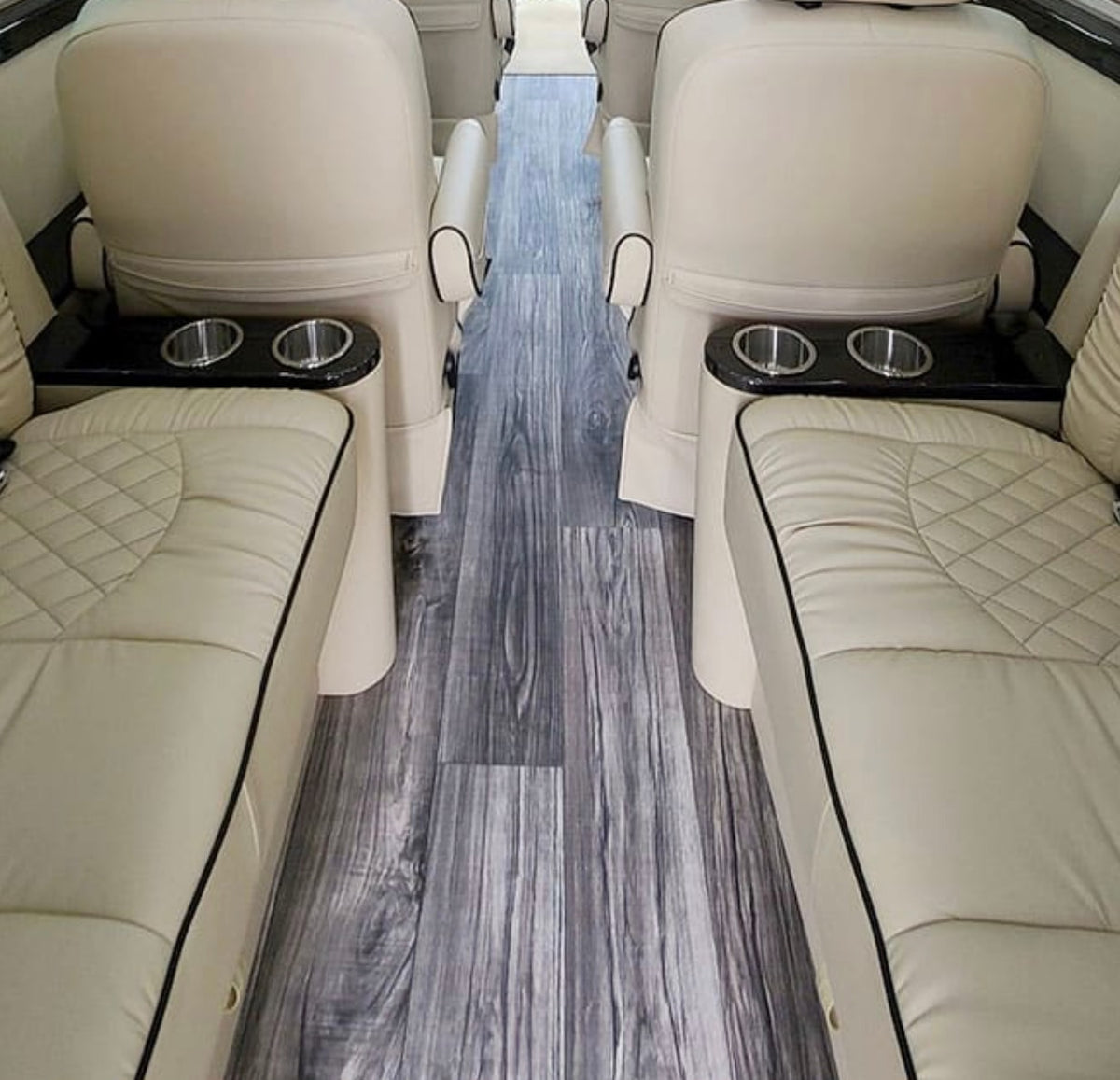  and controls for premium comfort.|Spacious luxury RV rental interior: cream quilted leather captain's chairs — photo 11