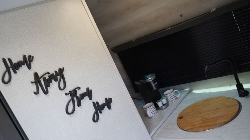  and deployed steps for camping.|White RV rental with its rear door open revealing a bed inside — photo 1