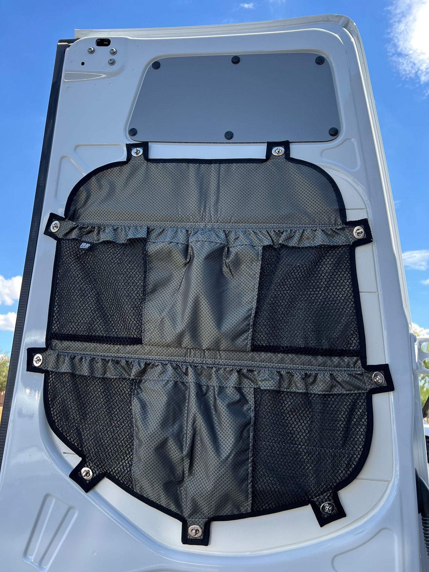 RV rental van's rear door with a multi-pocket fabric organizer, providing practical storage for essentials.