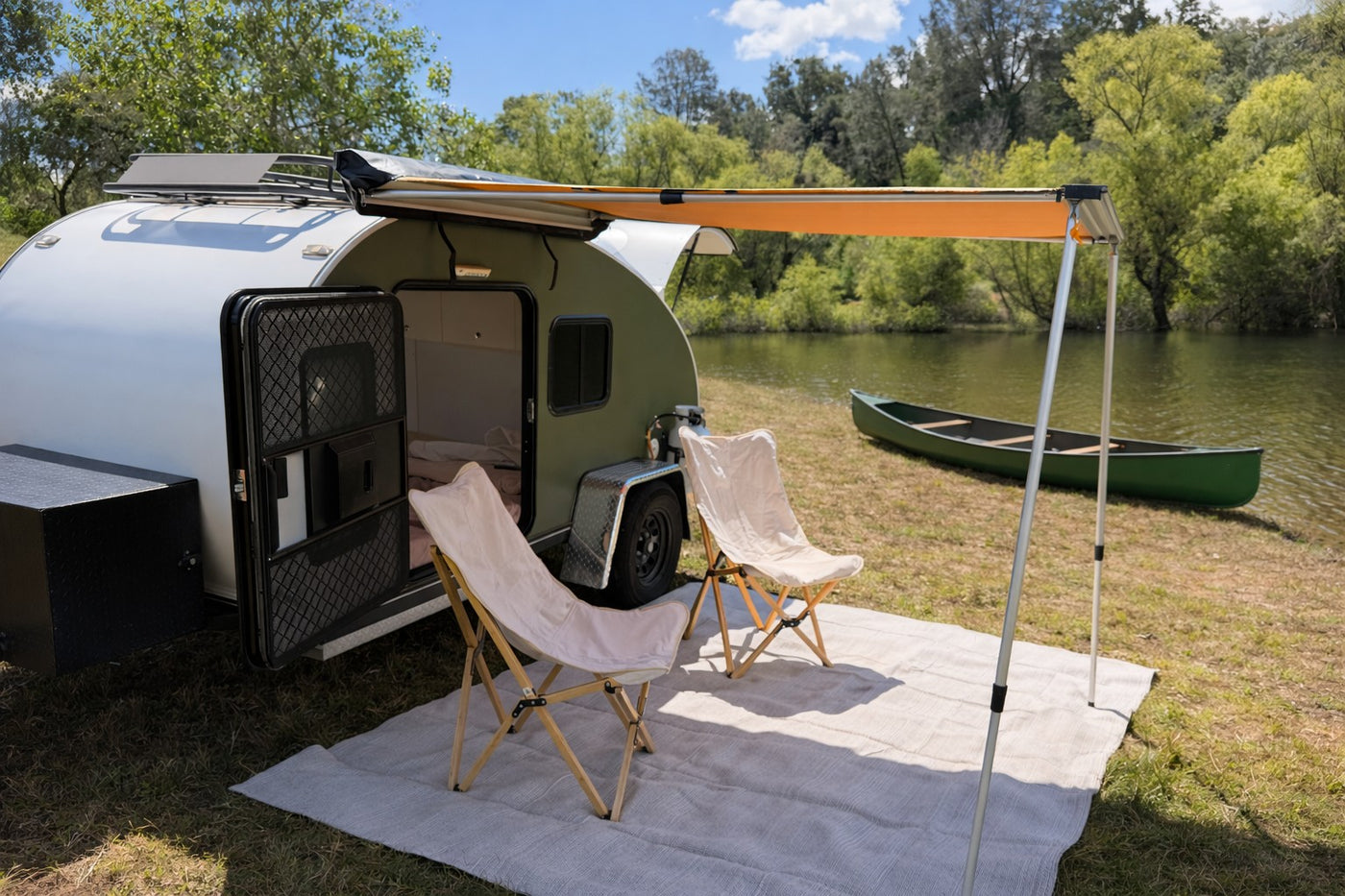  and string lights.|An RV rental adventure: White SUV tows a "CALIFORNIA TEARDROP" trailer by a scenic lake — photo 3