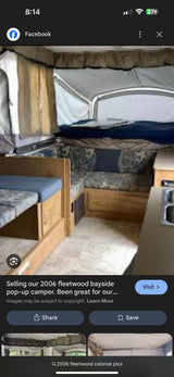 Spacious interior of a 2006 Fleetwood Bayside pop-up camper, perfect for an RV rental. Features sleeping areas, dinette, and small kitchen.