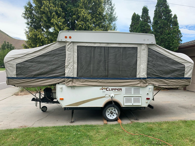 Pop-up RV rental: A Clipper by Coachmen, fully set up in a driveway with extended canvas, mesh windows, and stabilization jacks. — photo 5