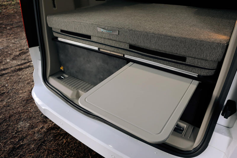 modern RV rental interior showing ceiling with four LED lights and various ventilation features.|Close-up of an RV rental interior: a dark console with two cup holders extends between fabric seats — photo 8