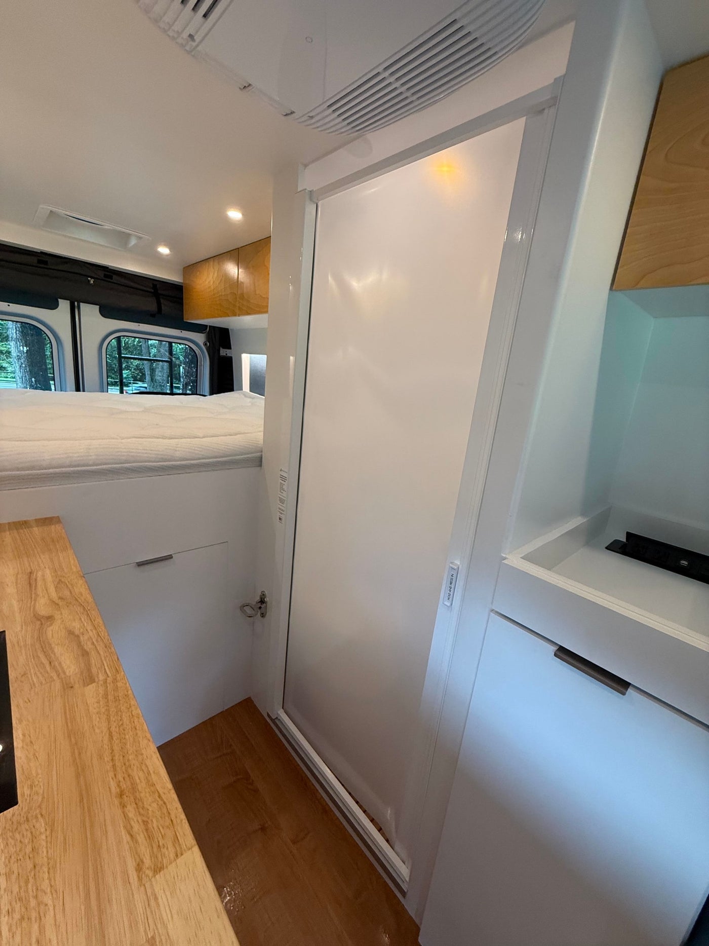  and small bathroom with a toilet.|RV rental interior: Convenient power outlet with USB for charging devices — photo 12