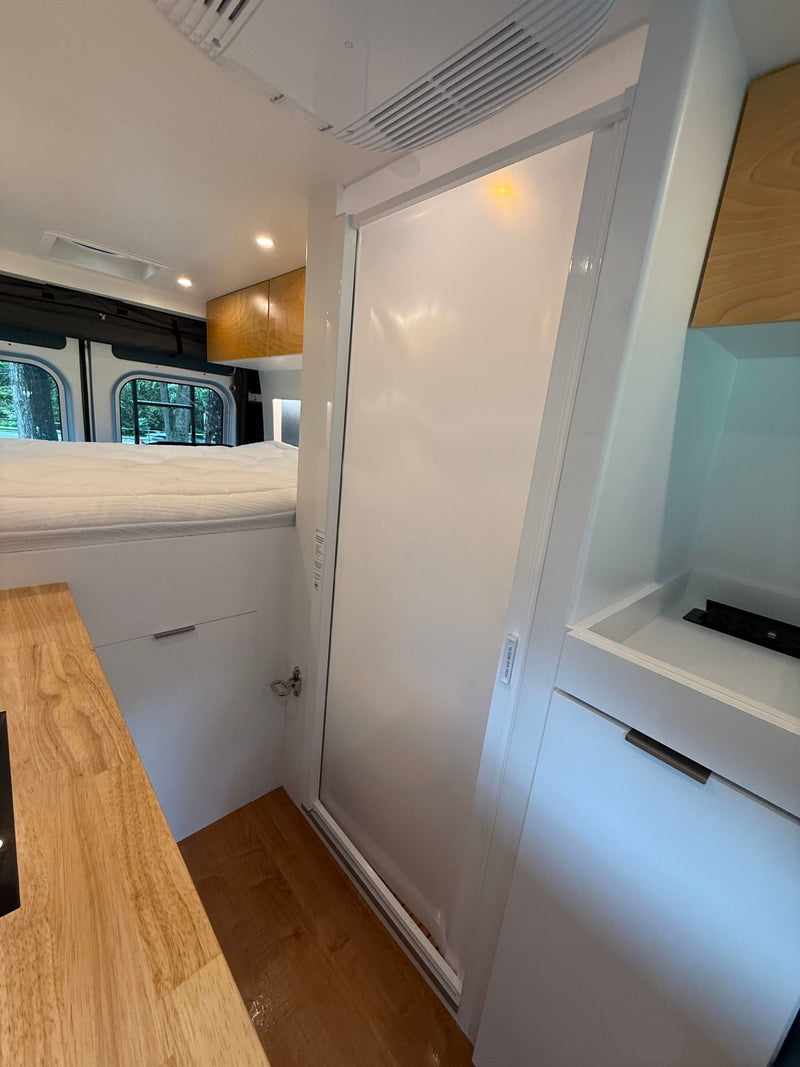  and small bathroom with a toilet.|RV rental interior: Convenient power outlet with USB for charging devices — photo 12