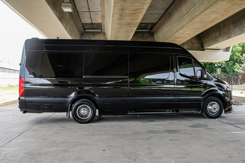 Black Mercedes-Benz Sprinter luxury van parked under a concrete overpass. Perfect for an RV rental or executive travel. — photo 11