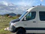 A rugged VanCraft camper van, ideal for RV rental adventures, parked in a scenic mountain landscape.