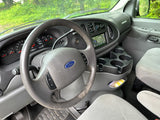 Driver's view in an RV rental van. Shows a worn Ford steering wheel, dashboard (273k miles), and infotainment screen.