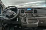 Inside a Ford rv rental van: driver's view of the dashboard, steering wheel, infotainment, and gear shifter.