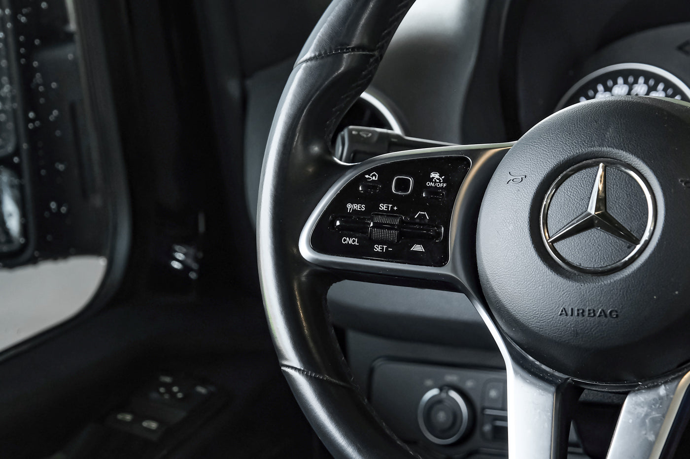 Modern car steering wheel with detailed controls for driver-assist systems. Similar sophisticated features can be found in premium RV rentals. — photo 17