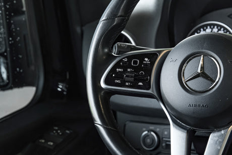 Modern car steering wheel with detailed controls for driver-assist systems. Similar sophisticated features can be found in premium RV rentals.