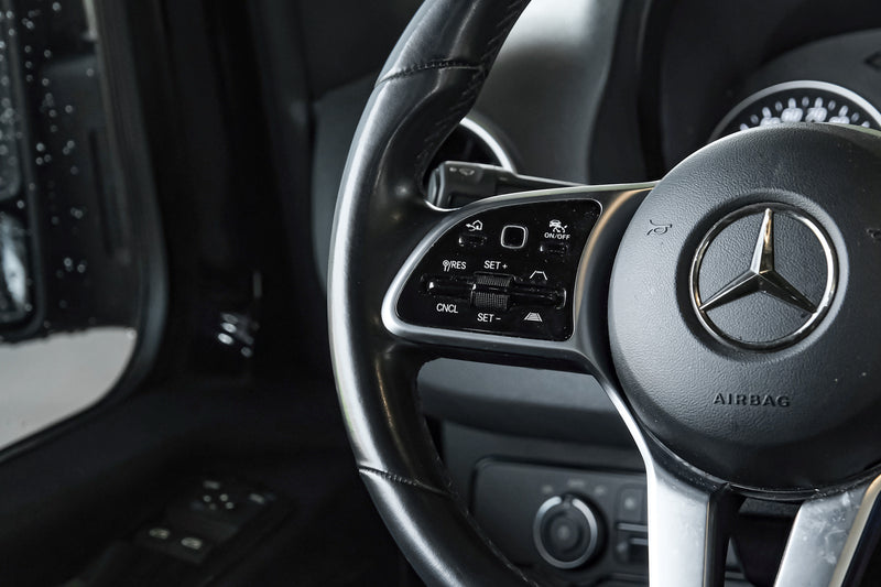 Modern car steering wheel with detailed controls for driver-assist systems. Similar sophisticated features can be found in premium RV rentals. — photo 17